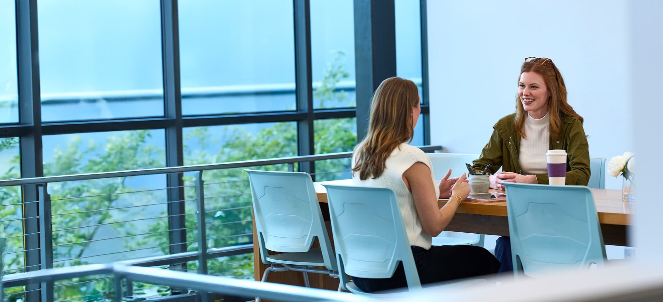 two women talking at table